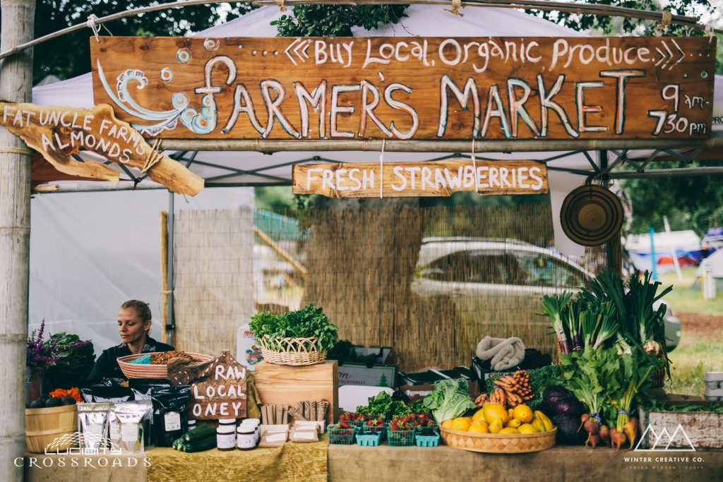 Local Farmer's Market storefront. "Fresh Strawberries" and "Raw Local Honey"